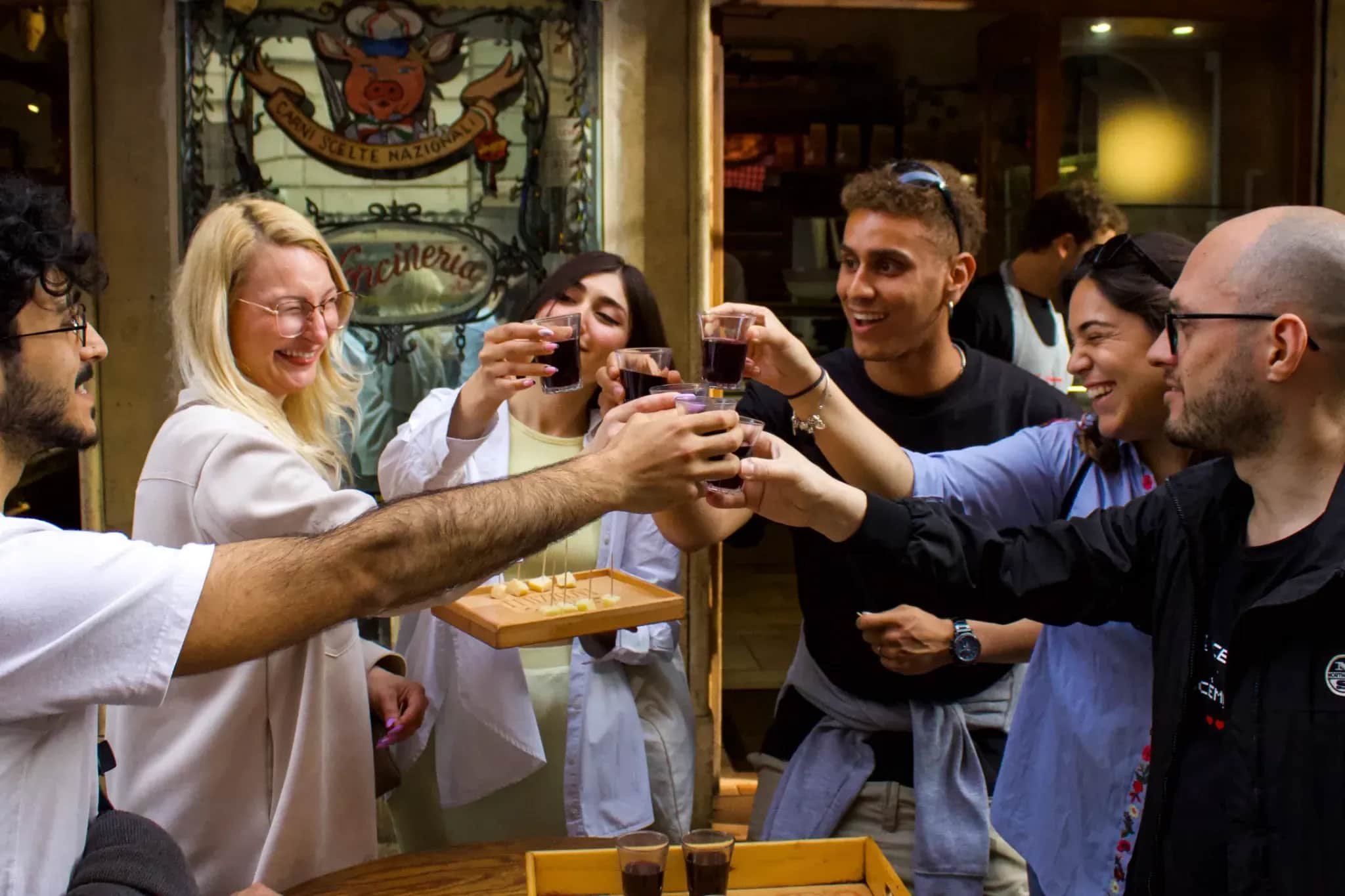 Group enjoying cold cheese and meat cuts with local wine on a Rome Food Tour through Trastevere