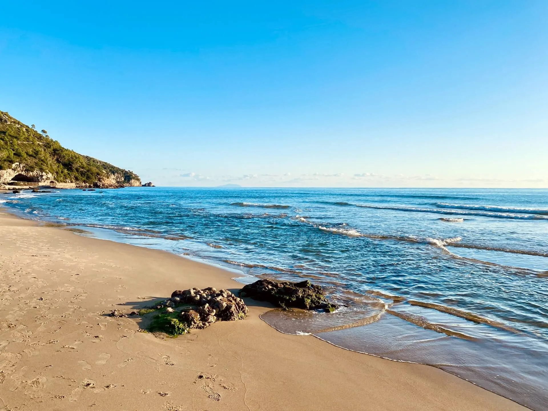 Scenic view of Sperlonga beach shoreline with blue water and sky, Italy