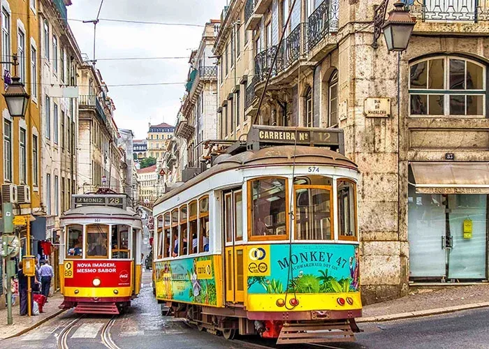 Historic yellow tram on Lisbon street showcasing budget-friendly tourist attractions and affordable travel experiences with Carpe Diem Tours Portugal