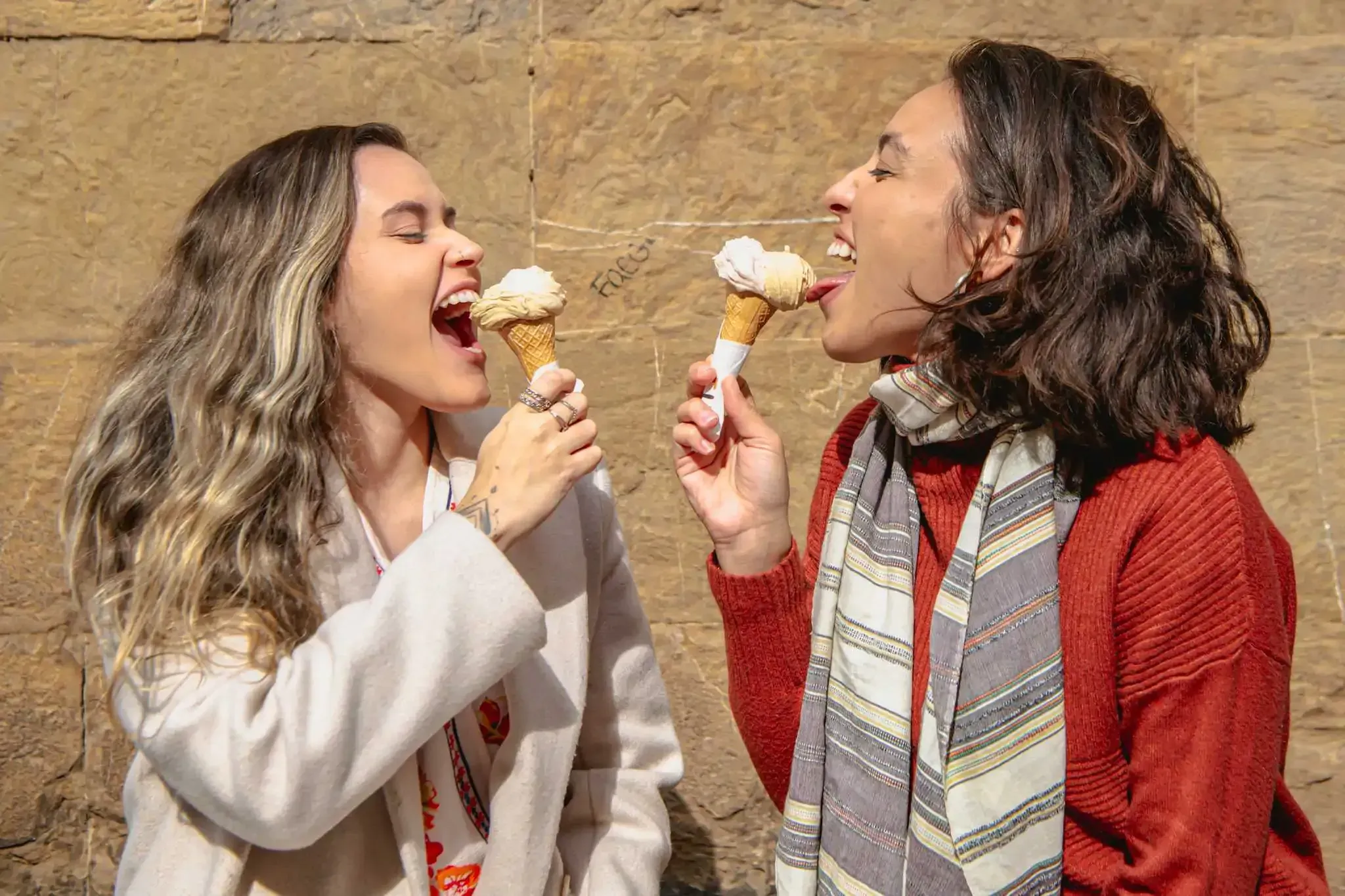 Happy tourists enjoying authentic Italian gelato ice cream during Carpe Diem Tours Florence food tour culinary experience and dessert tasting