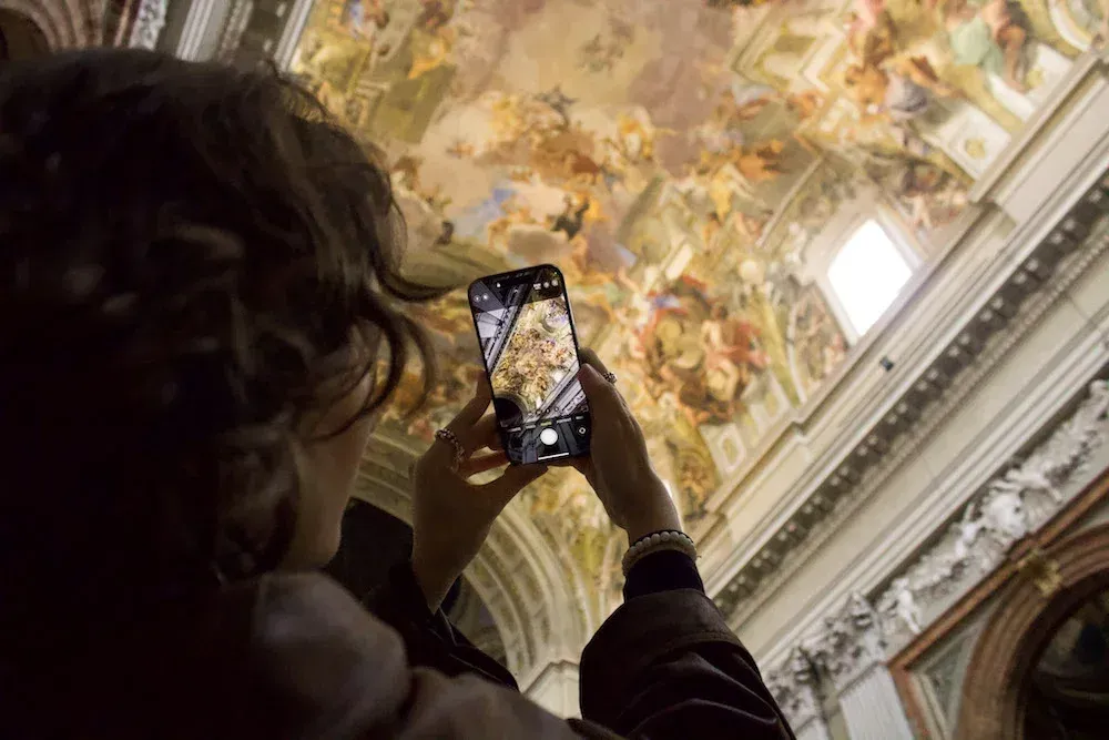 Stunning baroque ceiling frescoes and ornate artwork in historic Roman church showcasing religious art and cultural heritage during Carpe Diem Tours Rome