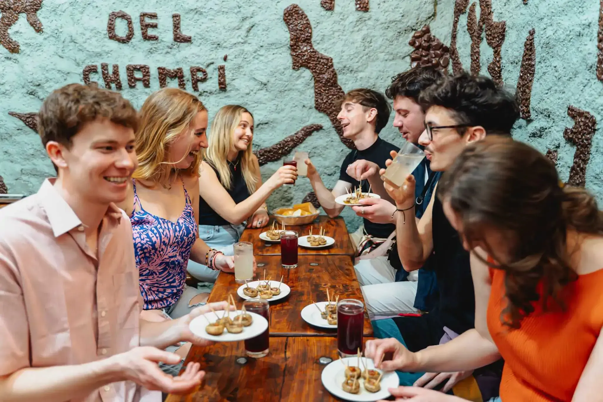 Group of tourists enjoying traditional Spanish food and drinks during Carpe Diem Tours Madrid culinary experience and food tour