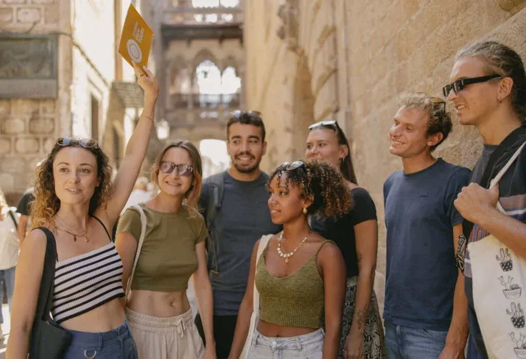 Happy group of tourists enjoying Barcelona Walking Tour showcasing diverse travelers and cultural exploration experience featured in Carpe Diem Tours Barcelona city exploration and historical educational adventures