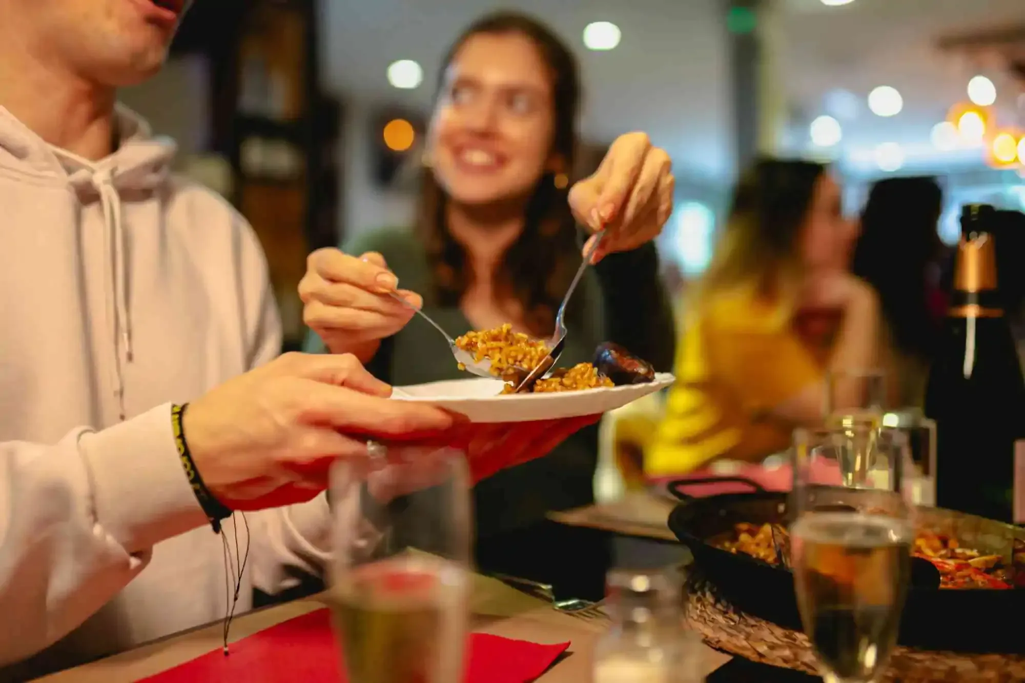 People enjoying paella during a Carpe Diem Barcelona Tipsy Tapas tour