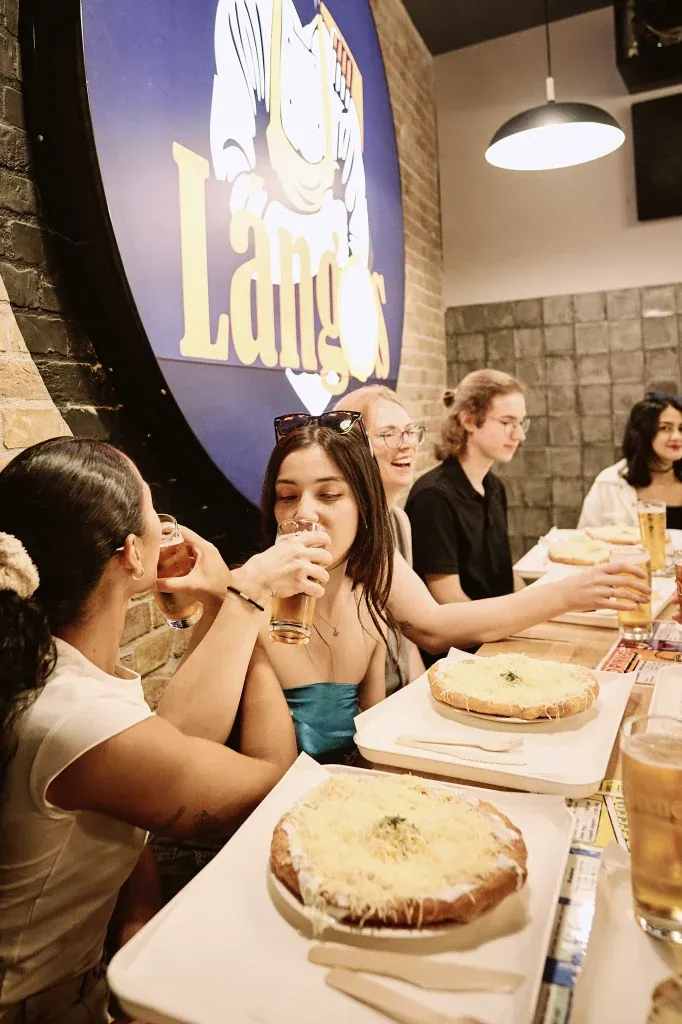 Budapest Food Tour group drinking beer before trying Lángos, a typical Hungarian dish