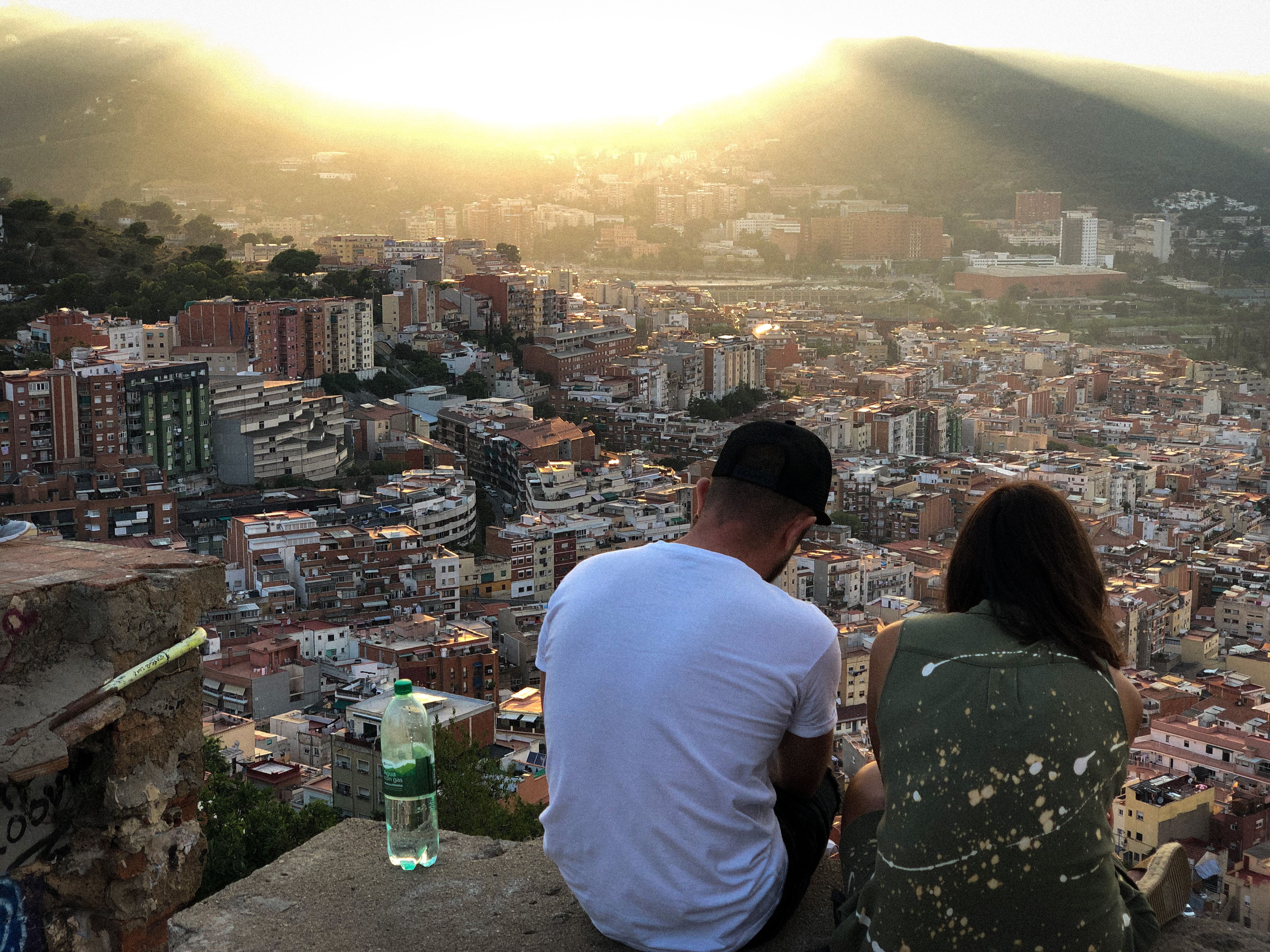 Couple sitting at the Bunkers del Carmel at sunset