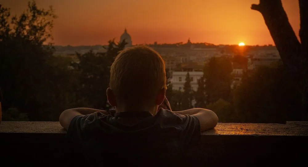 View of Rome city skyline from Aventine Hill at sunset