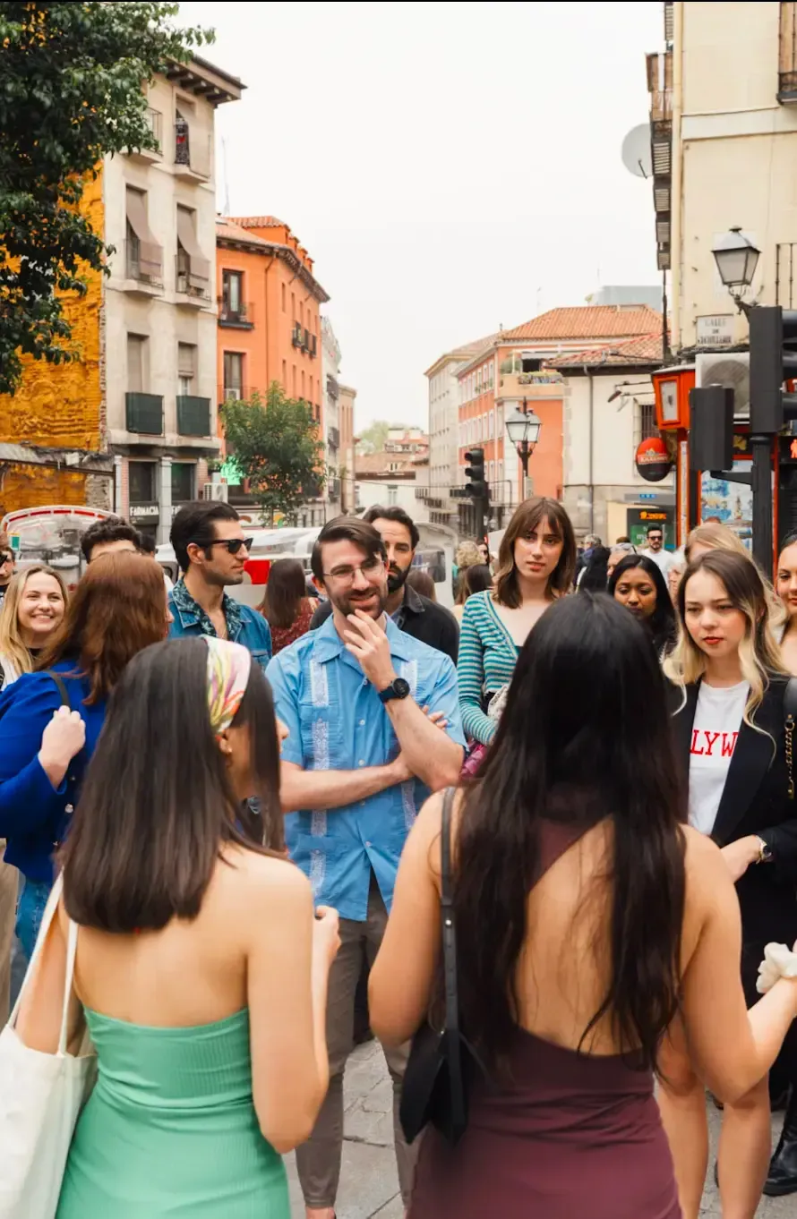 Group of tourists enjoying guided walking tour through historic Madrid streets during Carpe Diem Tours Spain cultural exploration and city sightseeing experience