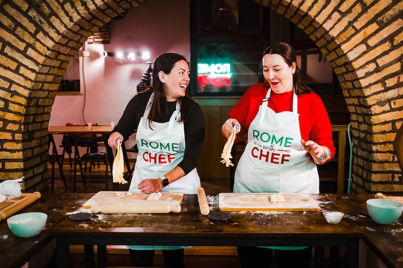 Young women enjoying a Spritz & Spaghetti Cooking Class in Rome