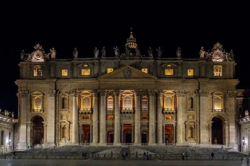 Vatican Saint Peter's Basilica illuminated at night with magnificent dome and colonnade showcasing papal architecture and religious heritage featured in Carpe Diem Tours Rome Vatican exploration and historical educational experiences