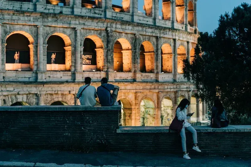 Stunning nighttime view of illuminated Colosseum exterior showcasing ancient Roman architecture during Carpe Diem Tours Rome evening sightseeing experience