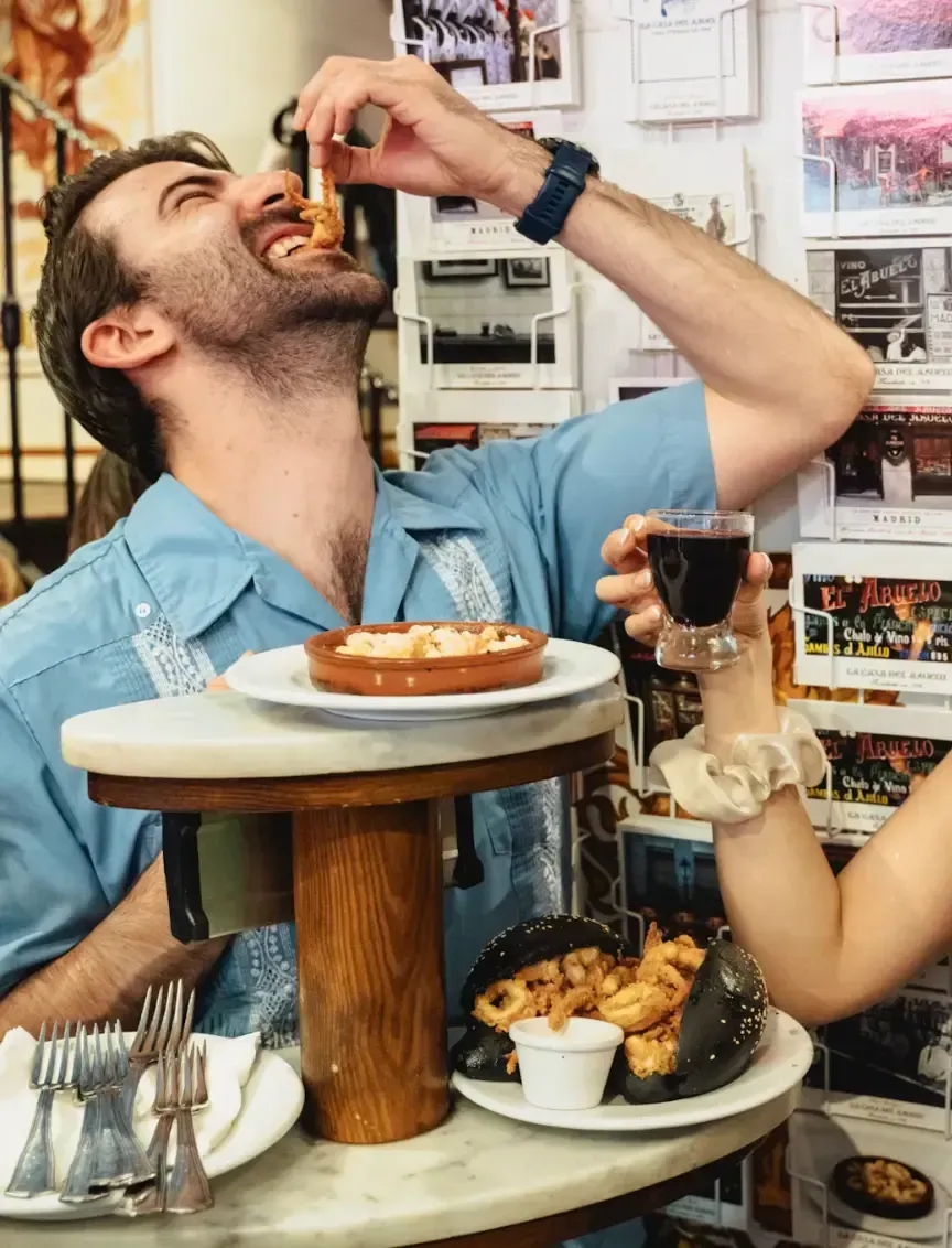 Tourist enjoying delicious traditional Spanish pastry and coffee during Carpe Diem Tours Madrid food tour culinary experience and authentic local cuisine tasting