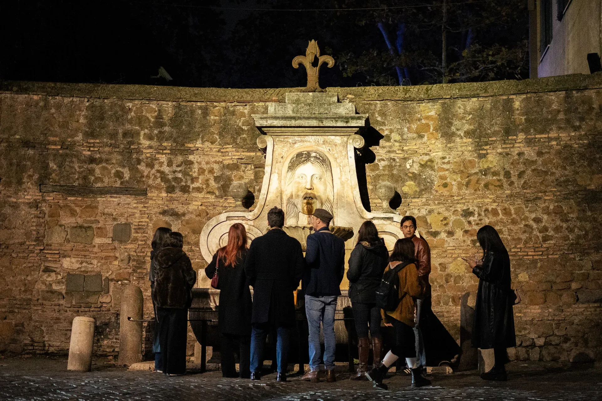 Tourists gathered around an ancient, dimly lit fountain in Rome to hear a ghost story