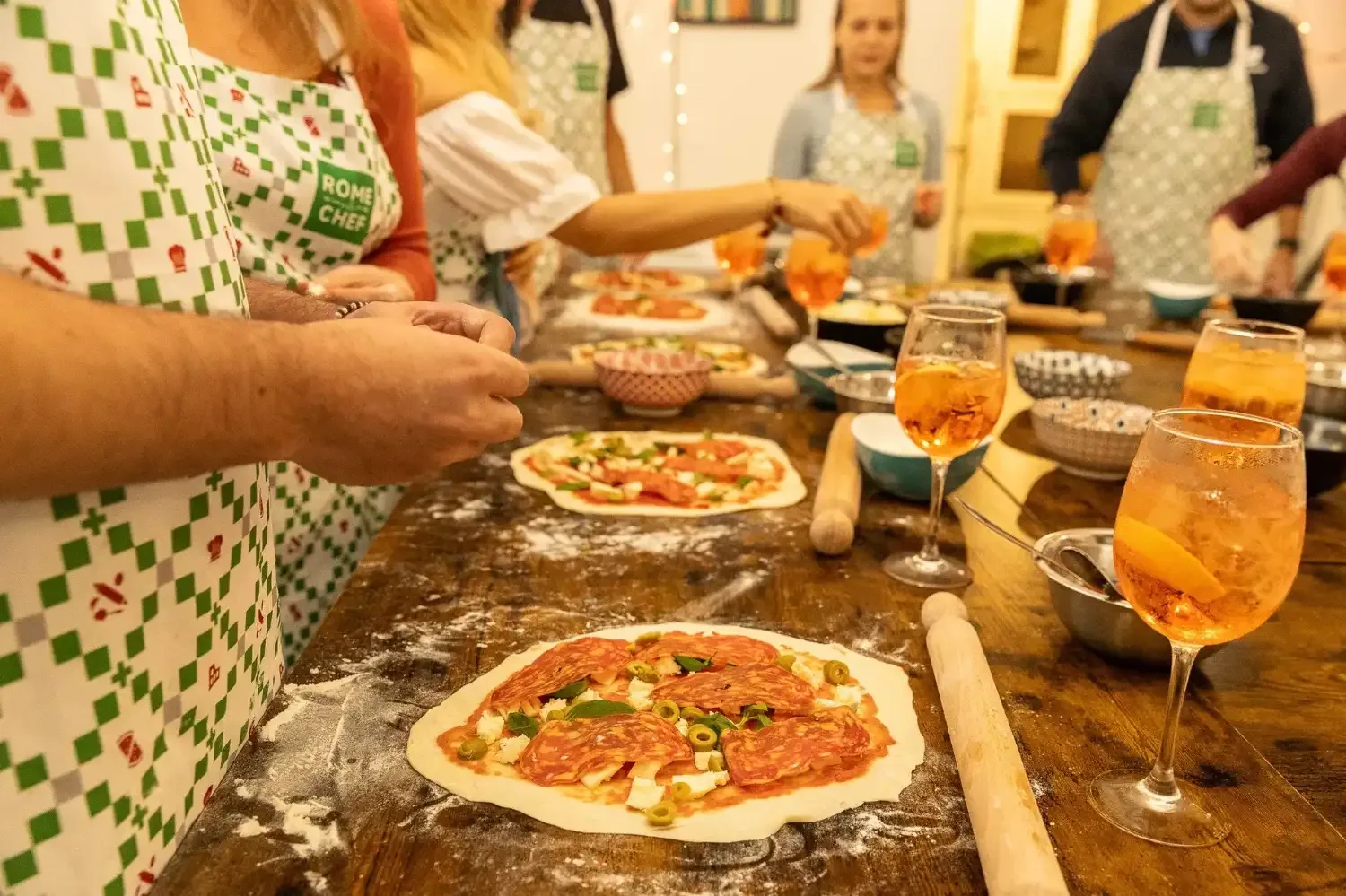 Close-up of Aperol Spritz cocktail with fresh orange slice on wooden table during Rome cooking class