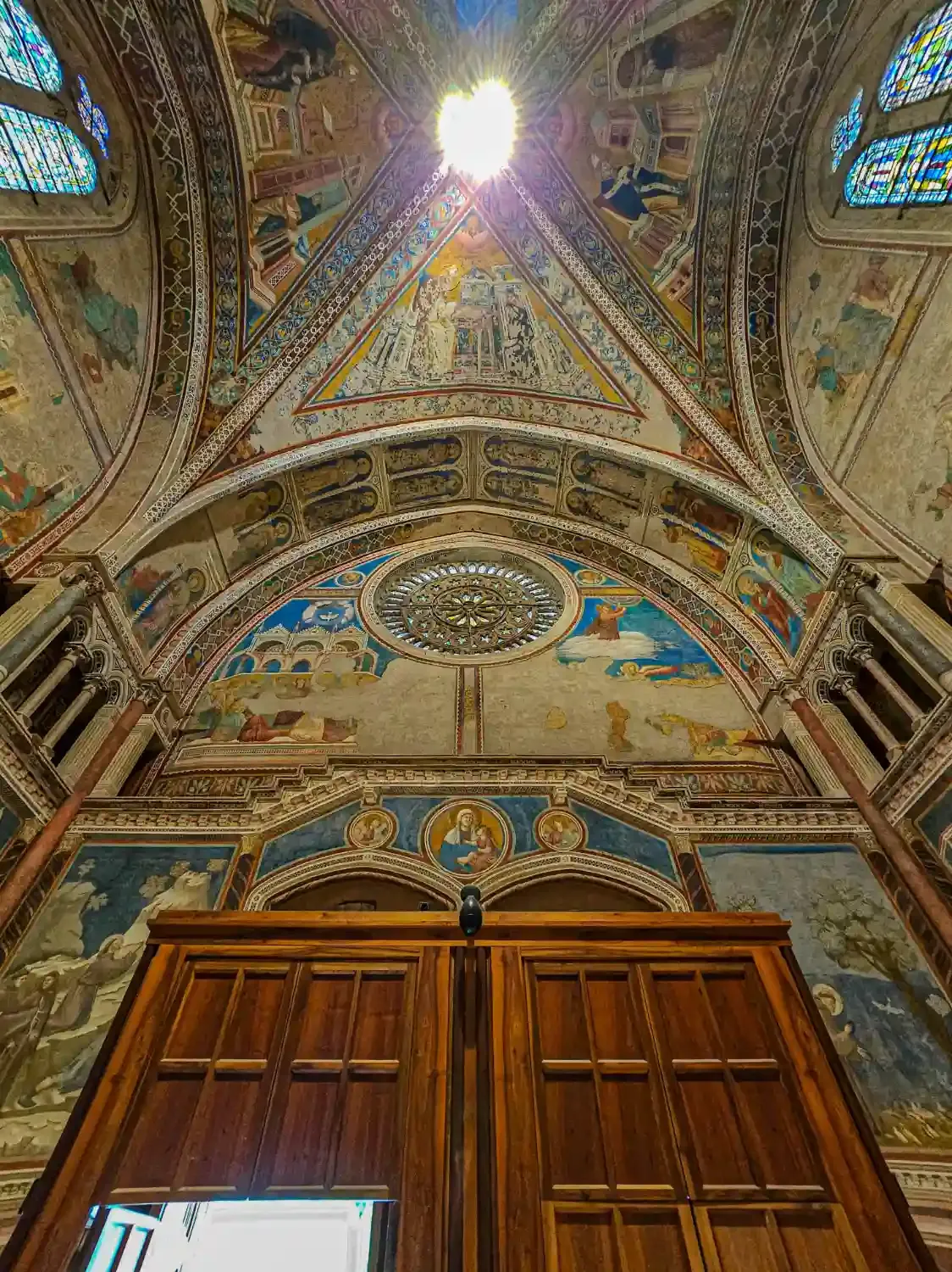 Basilica interior with painted ceiling frescoes ornate architectural details and religious iconography