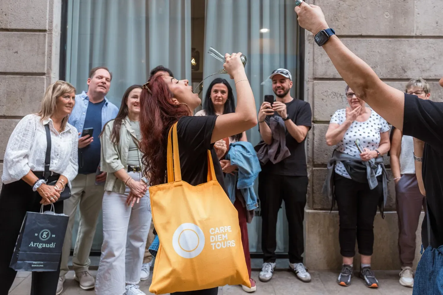 Carpe Diem Tours guide demonstrating the traditional porrón wine pour on the Barcelona Food Tour