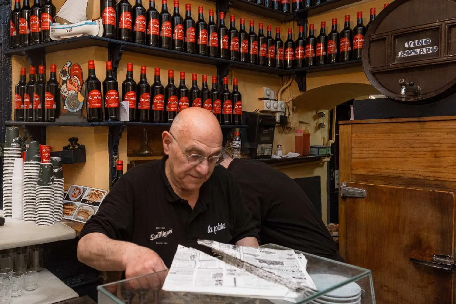 Guests toasting with vermouth and tapas at a traditional Barcelona bodega