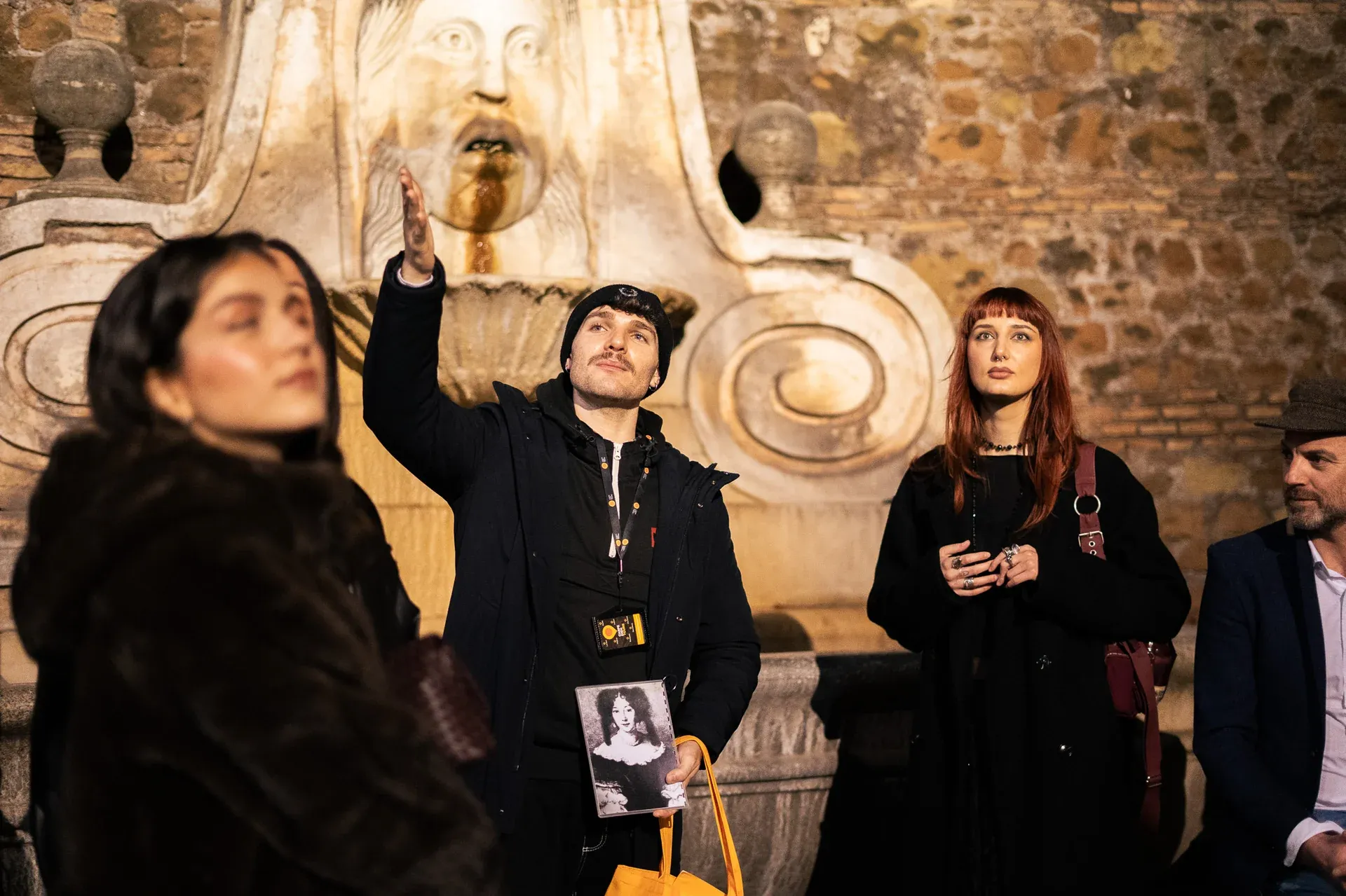A guide standing near the Bocca della Verità (Mouth of Truth) during a ghost tour of Rome.