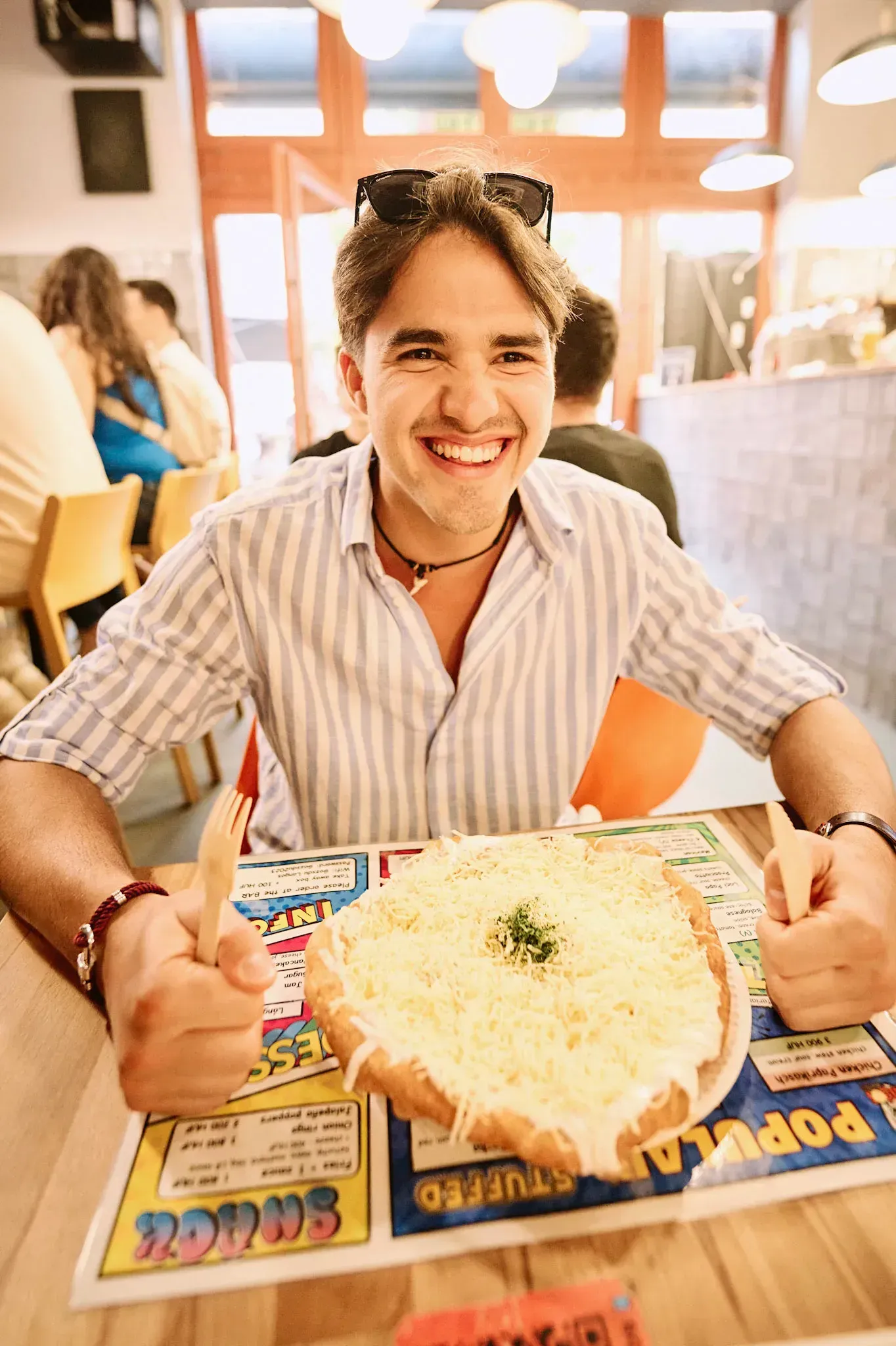 Client enjoying authentic lángos on a Budapest Food Tour