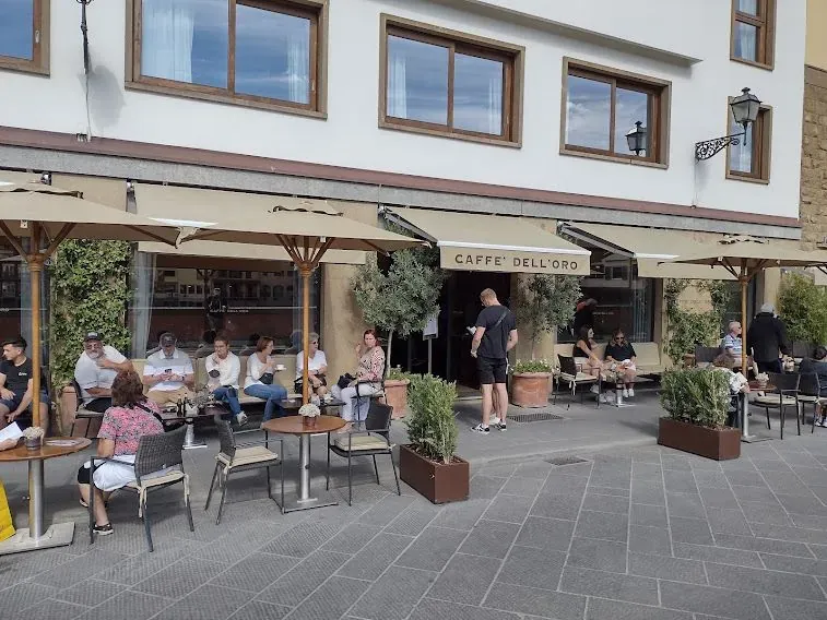 Exterior view of Caffe dell'Oro restaurant with outdoor seating in Florence, Italy