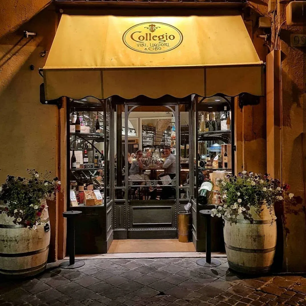 The charming entrance to Collegio, a fine dining restaurant in Rome, illuminated at night."