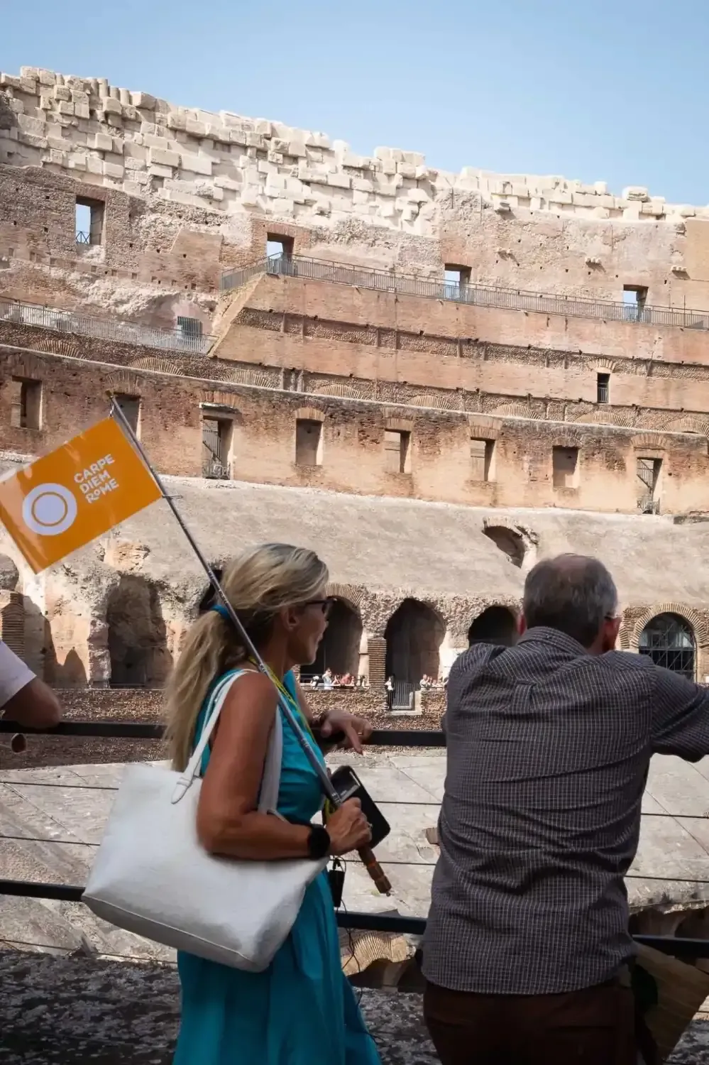 Group exploring the Colosseum arena with views of Palatine Hill and Roman Forum