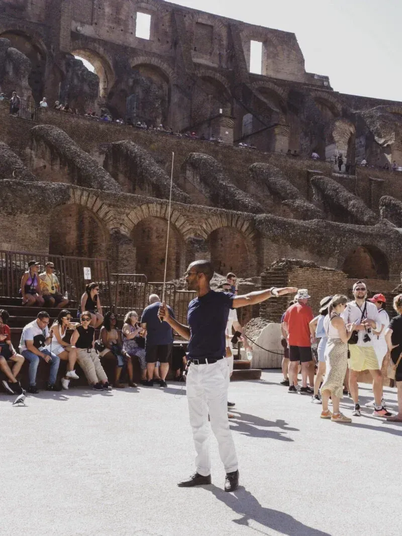 Small group of travelers on the Colosseum arena floor tour in ancient Rome