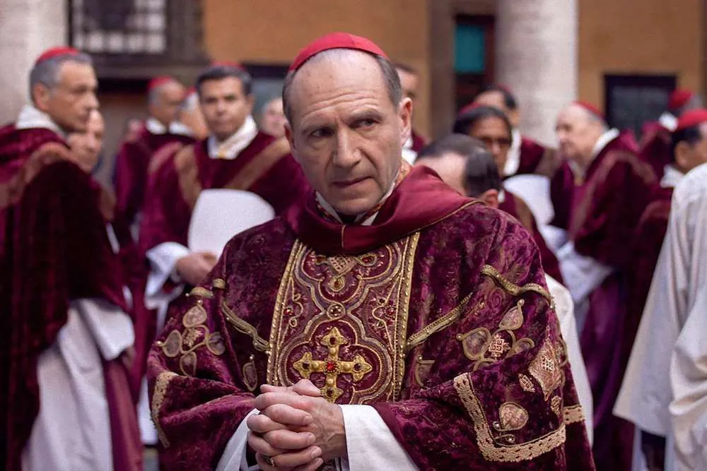 Cardinal in red robes during a conclave, possibly in the Vatican.