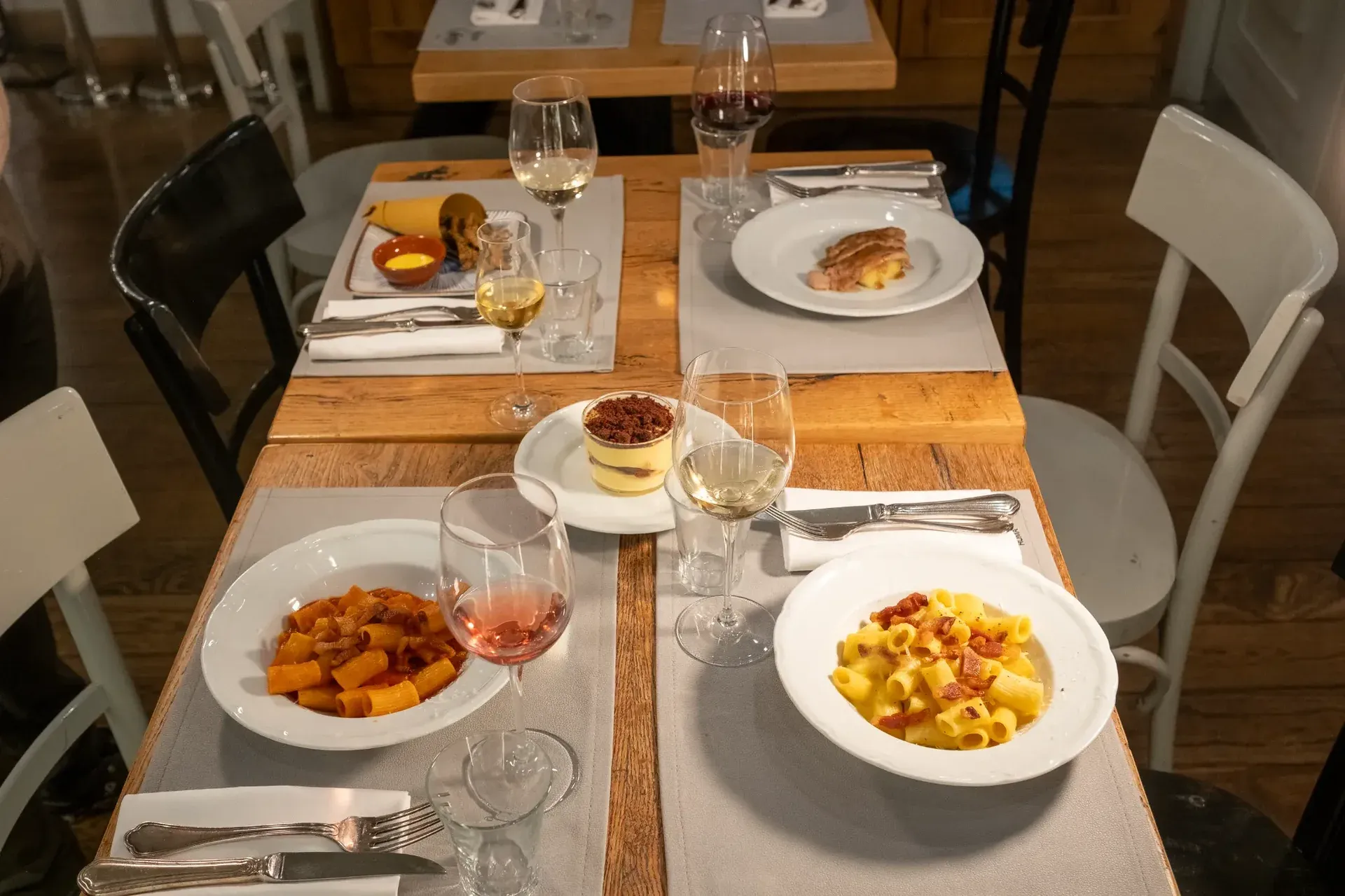 Two delicious pasta courses, including carbonara, served with wine pairings at a fine dining restaurant.