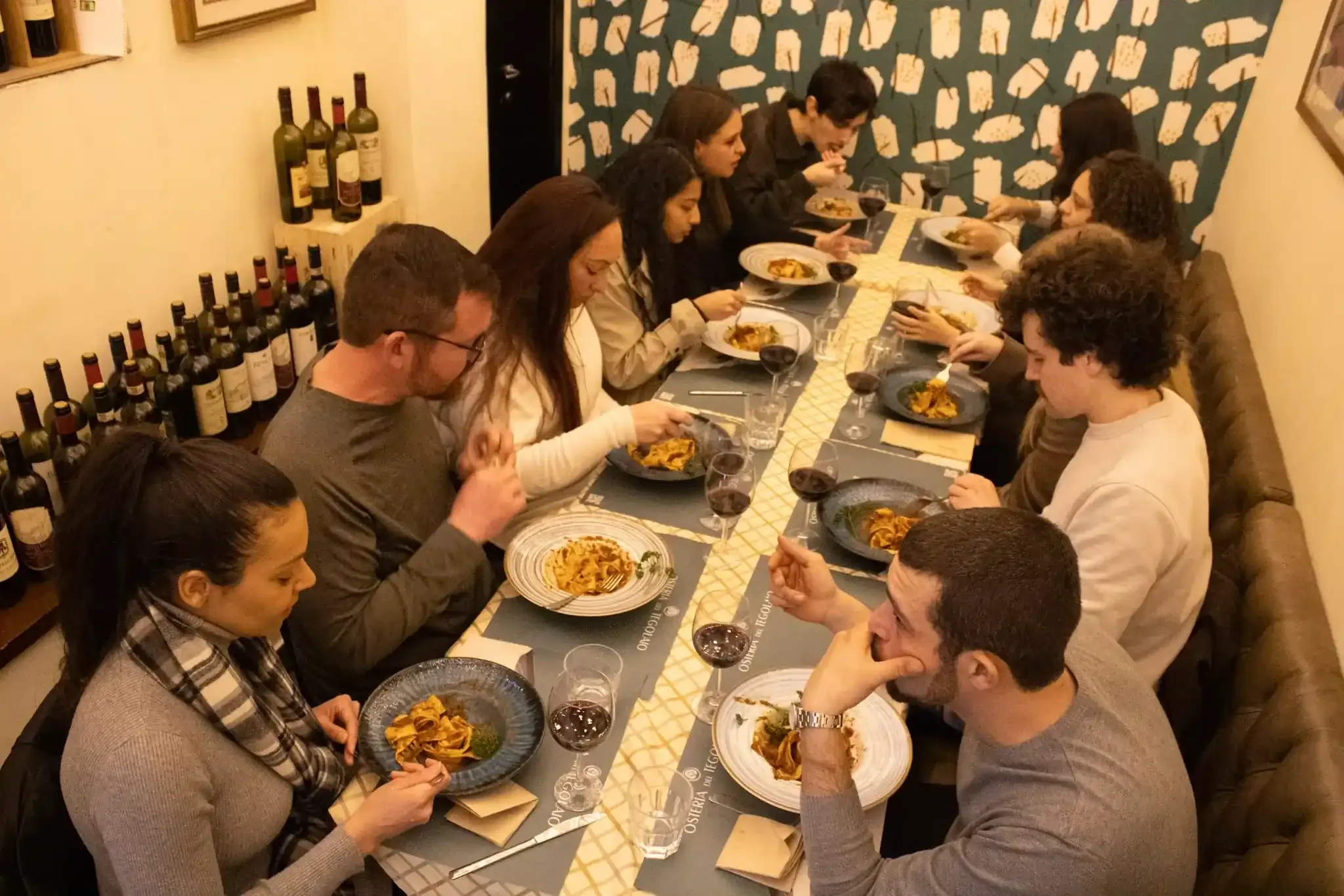 Group of tourists dining together at Florence food tour with authentic Italian cuisine and wine