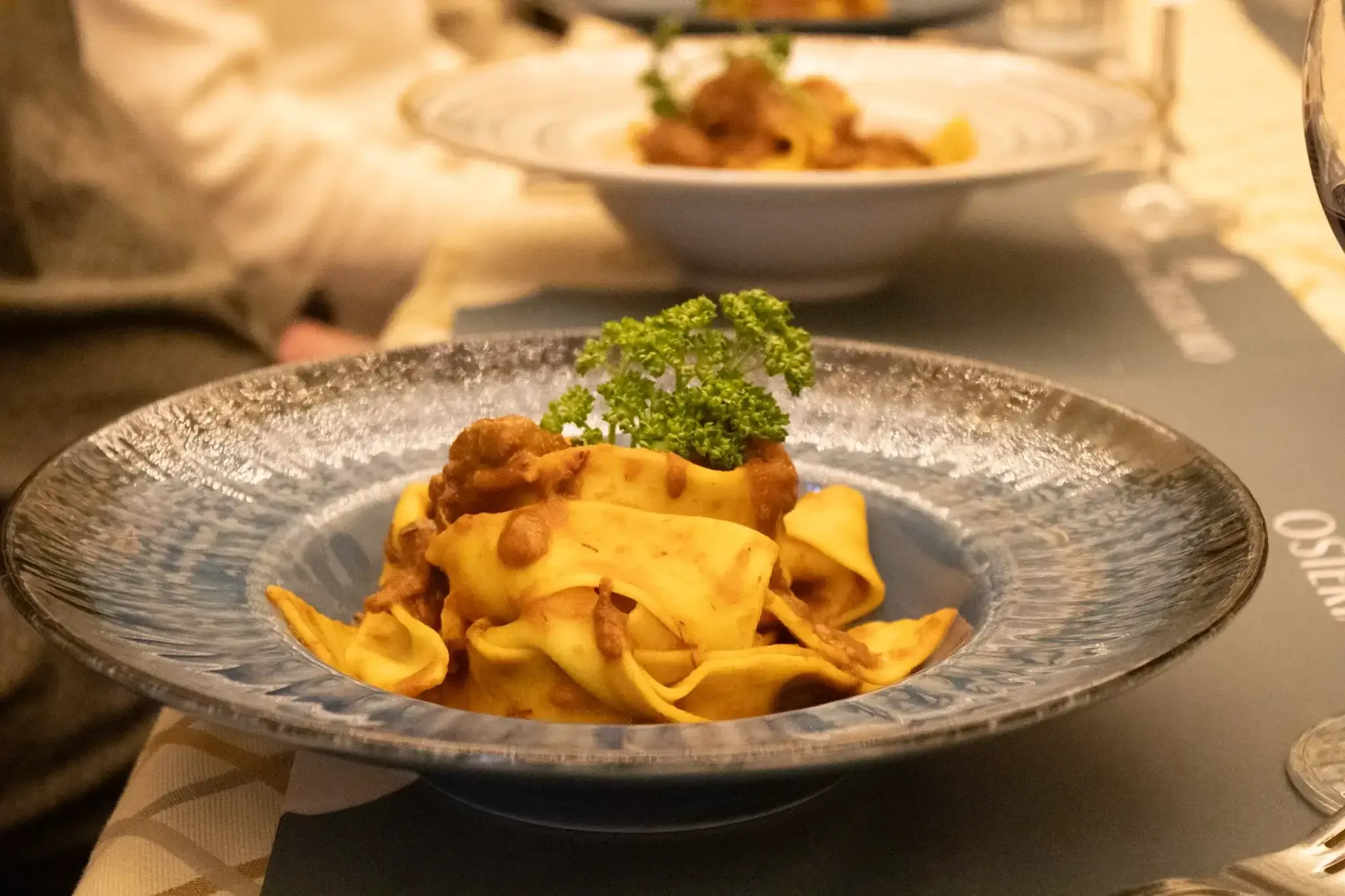 Artfully presented Italian pasta dish with fresh parsley garnish at Florence food tour restaurant