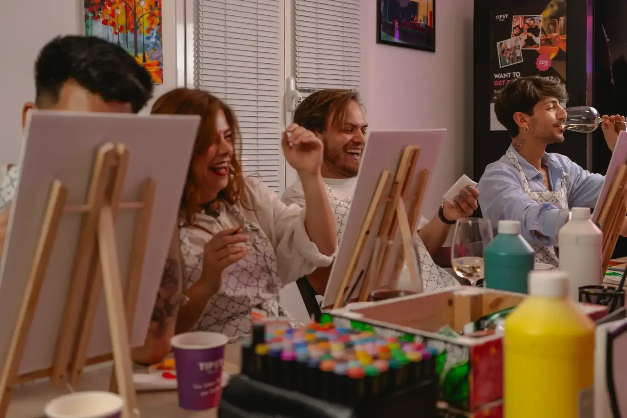 Group of participants enjoying wine while painting together in Rome art studio class