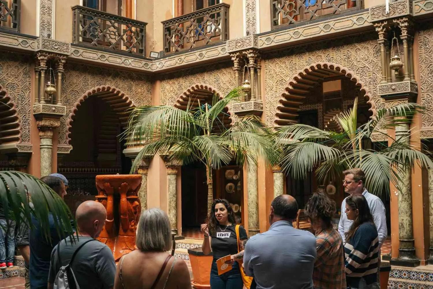 Carpe Diem Tours guide explaining Lisbon history inside a hidden Moorish-style courtyard