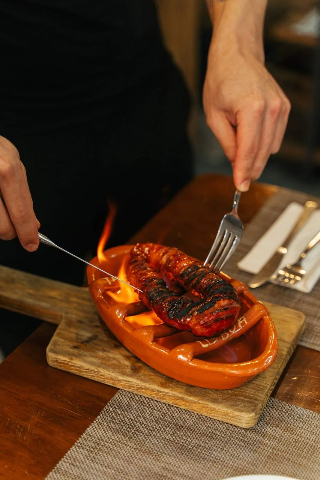 Chouriço grilled to order and flambéed tableside as a petisco on the Lisbon Food Tour