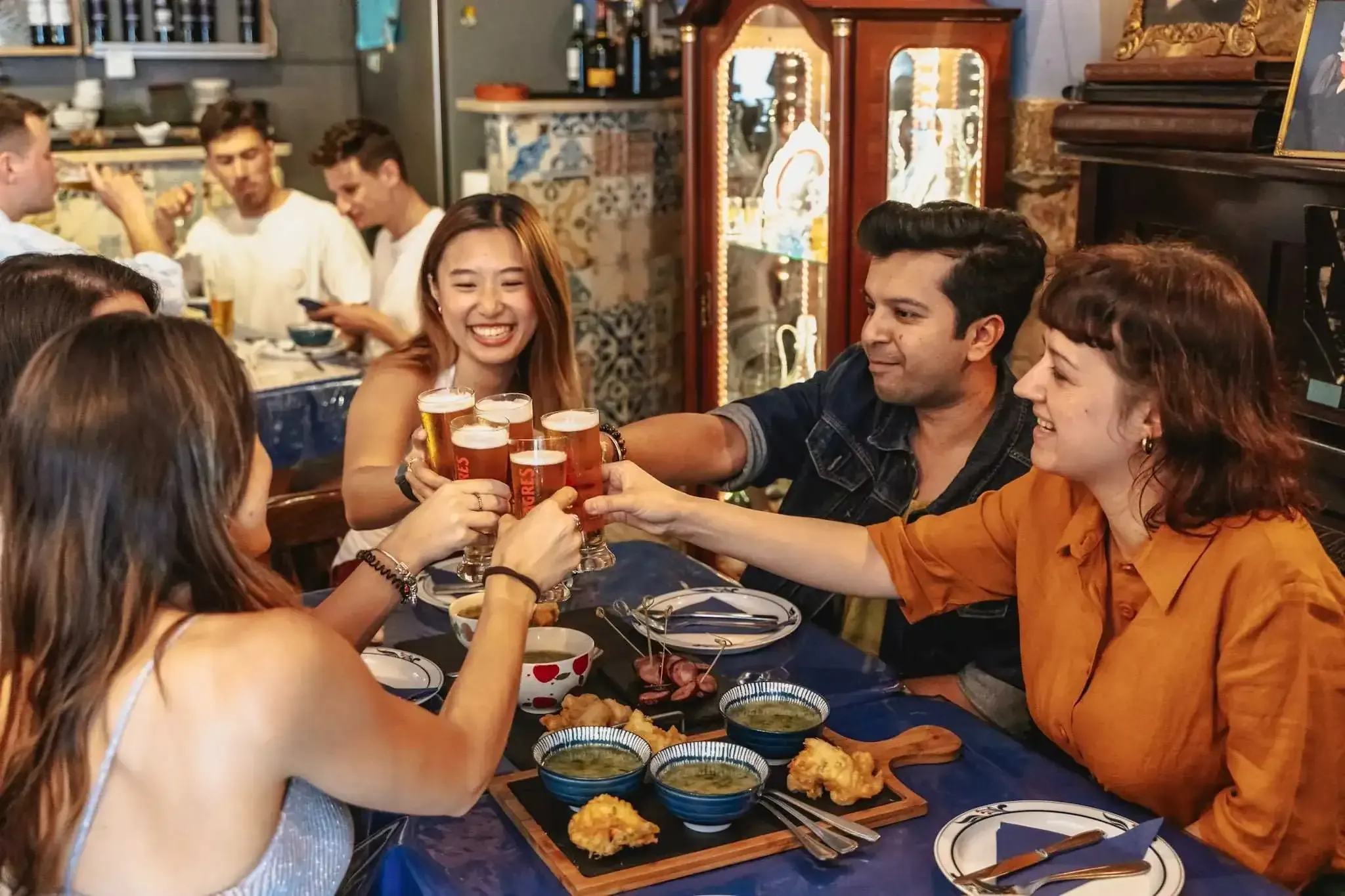 Travelers toasting with drinks on Lisbon food tour