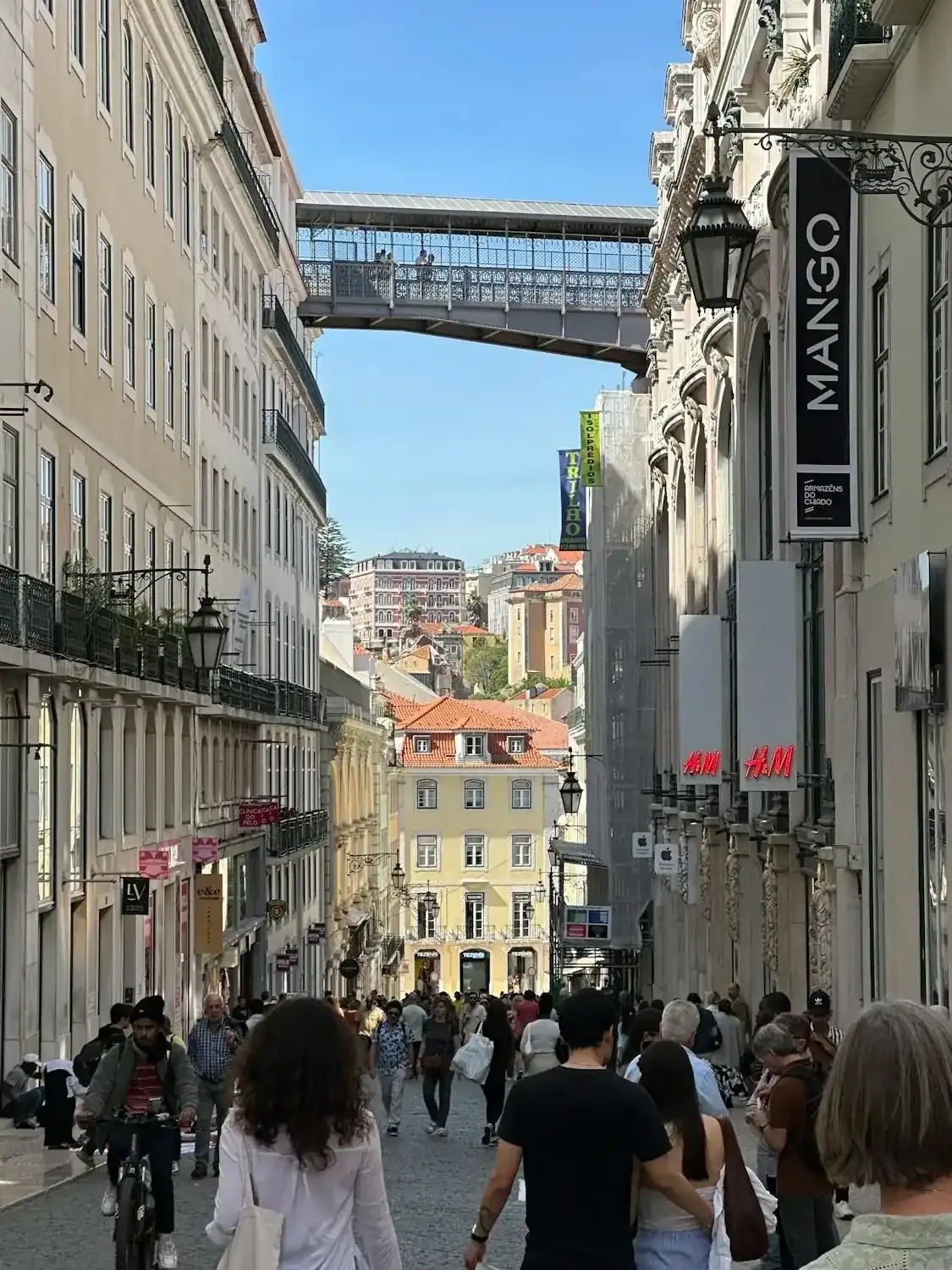 Busy street with Santa Justa lift visible on Lisbon walking tour