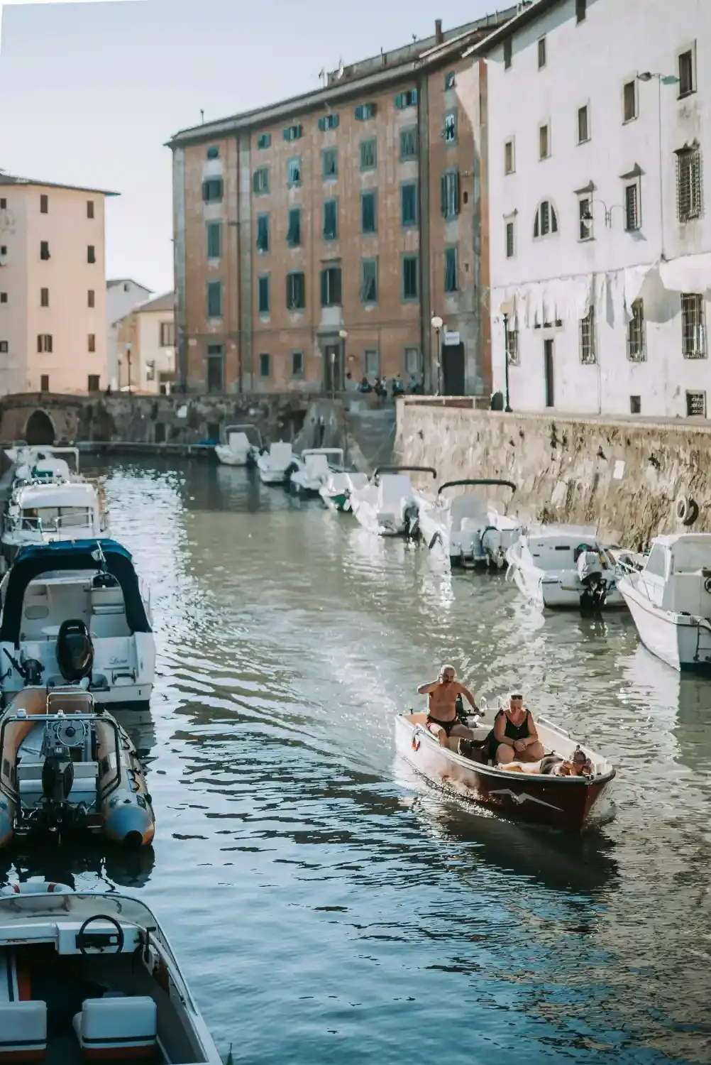 Livorno harbor with traditional fishing boats historic buildings and turquoise Mediterranean water