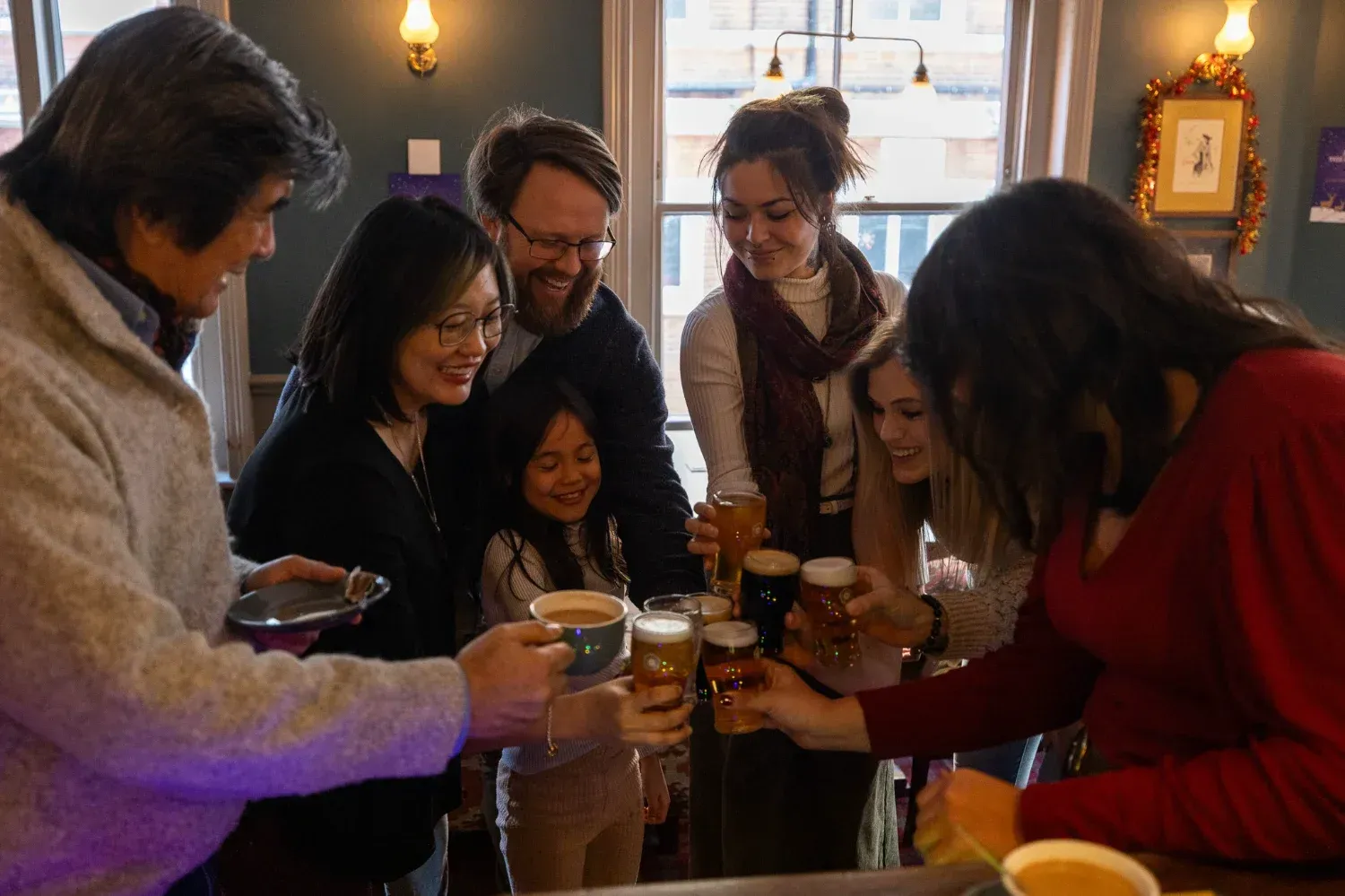 Group of travelers enjoying food and conversation at evening London Soho Food Tour event