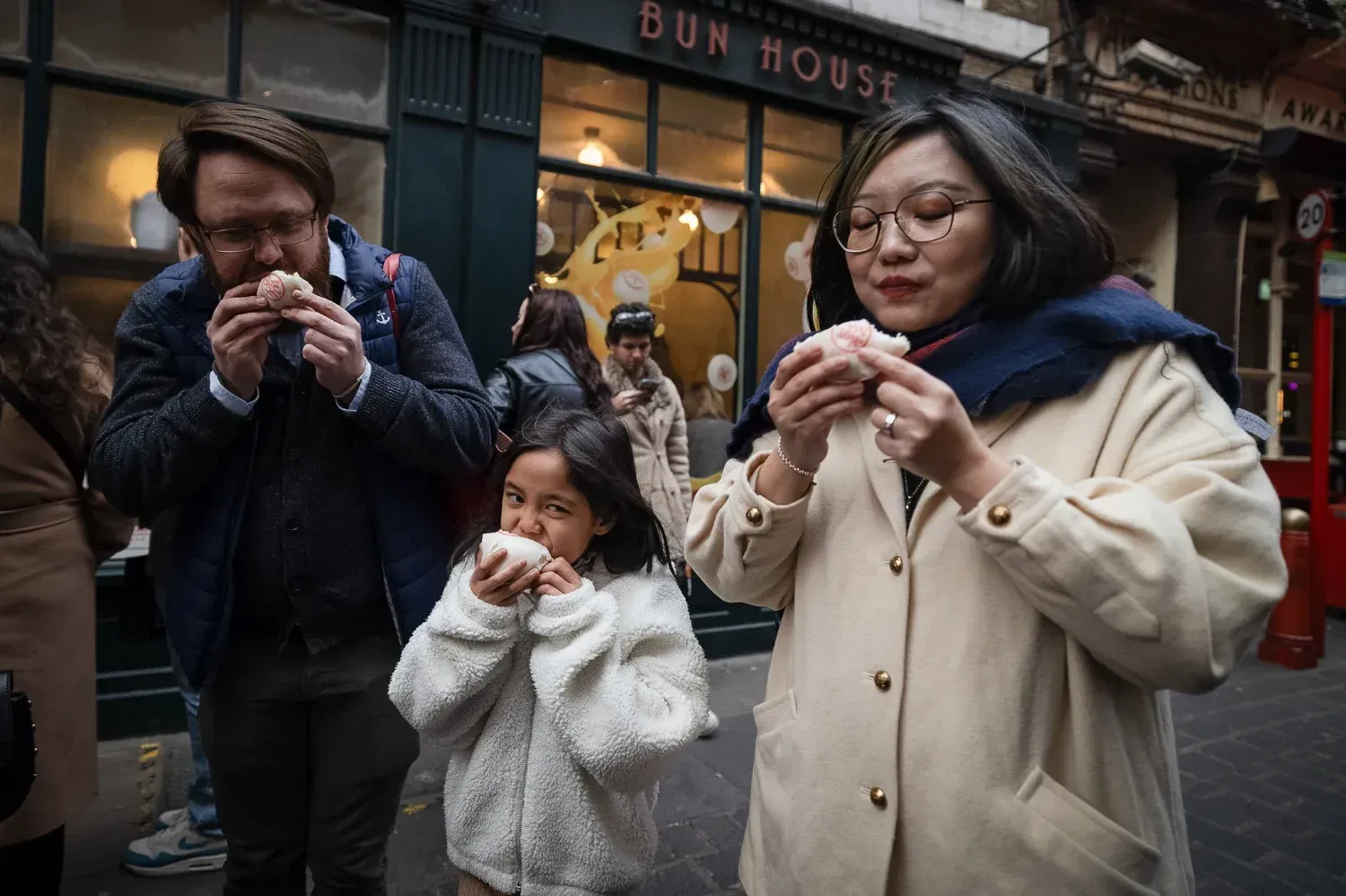 Intimate group of travelers enjoying conversation and wine at cozy restaurant during London Soho Food Tour
