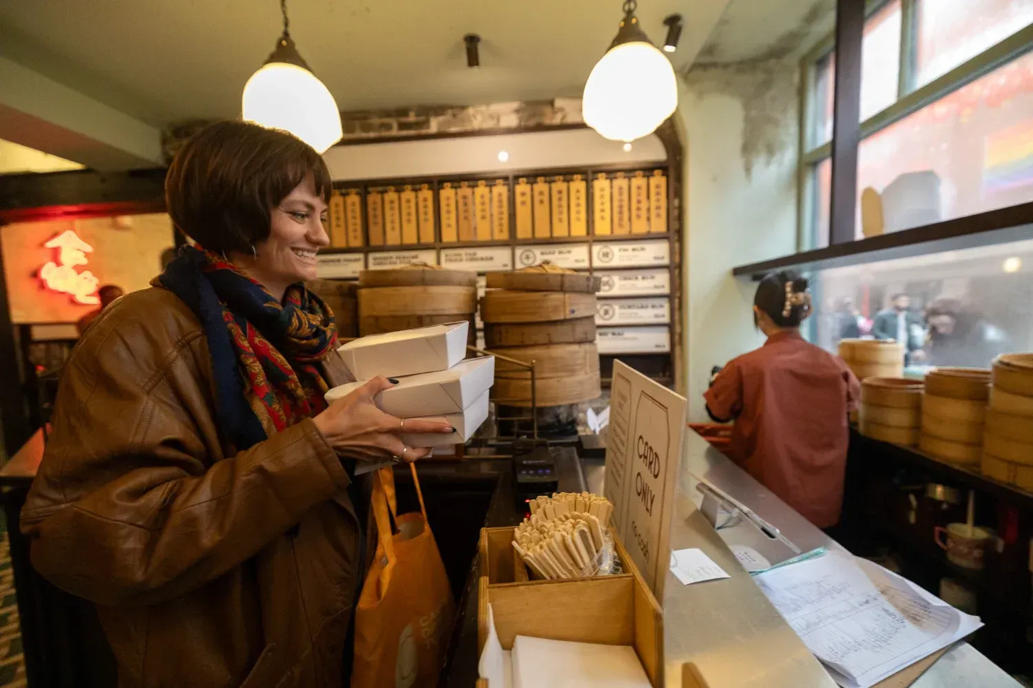 Travelers enjoying food and wine in warm rustic restaurant setting during London Soho Food Tour