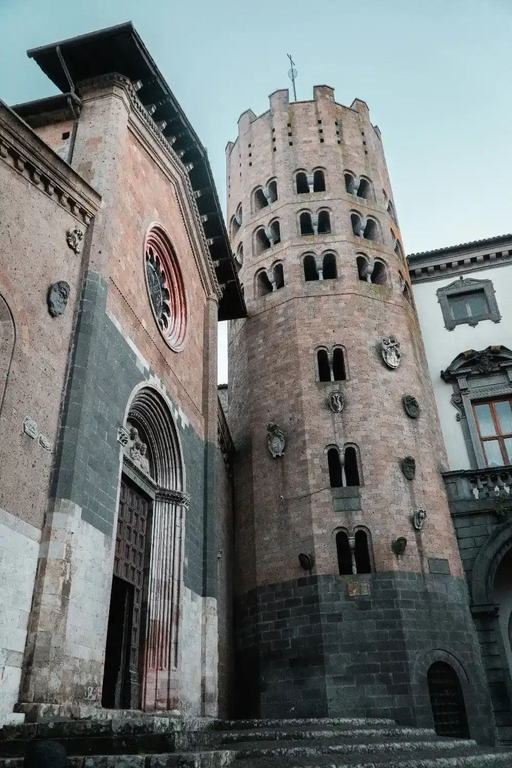 Historic medieval tower and church in Orvieto with Romanesque architecture and traditional Italian stonework
