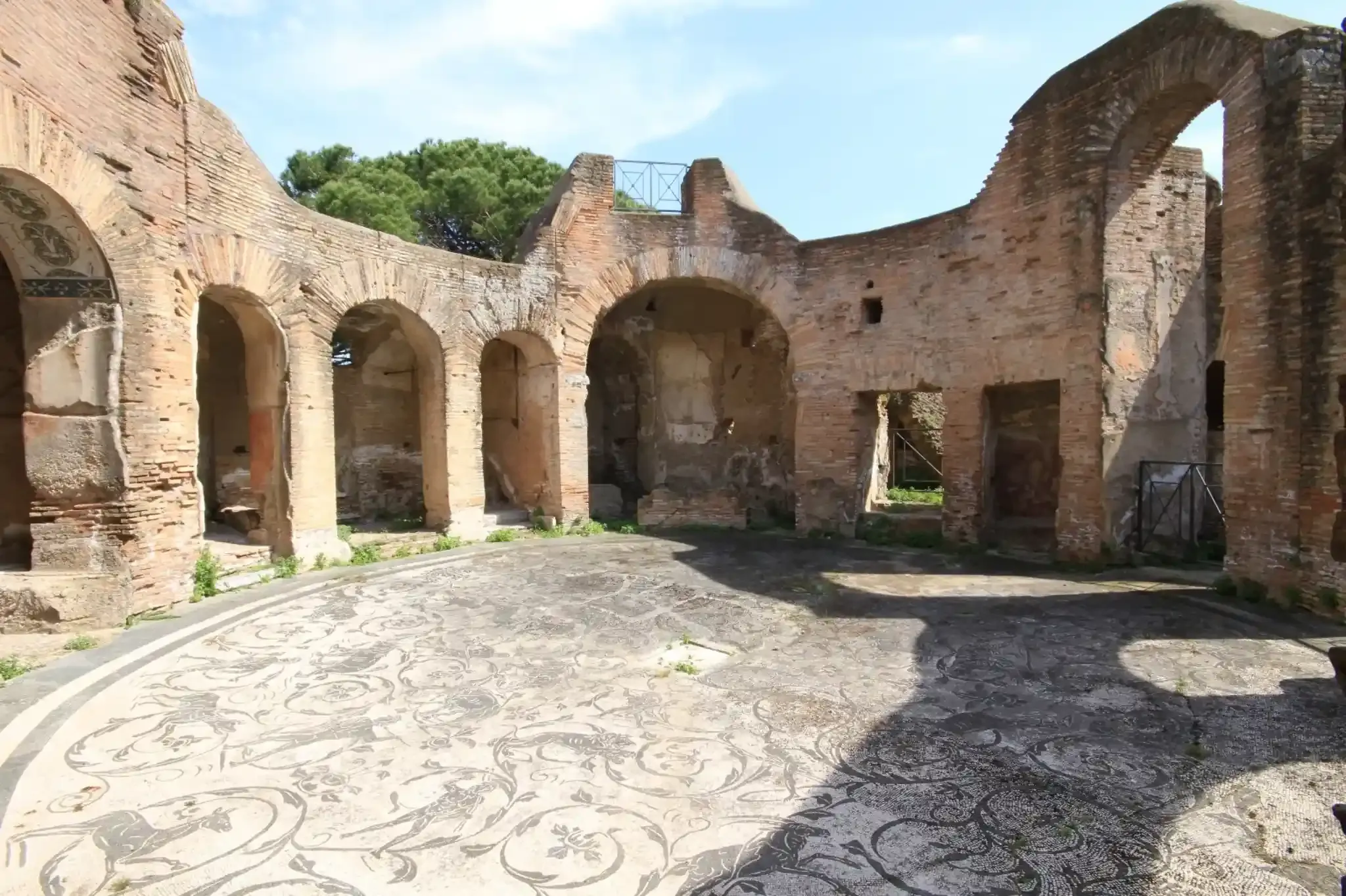 Decorative mosaic floor in Roman bathhouse with ornamental patterns at Ostia Antica