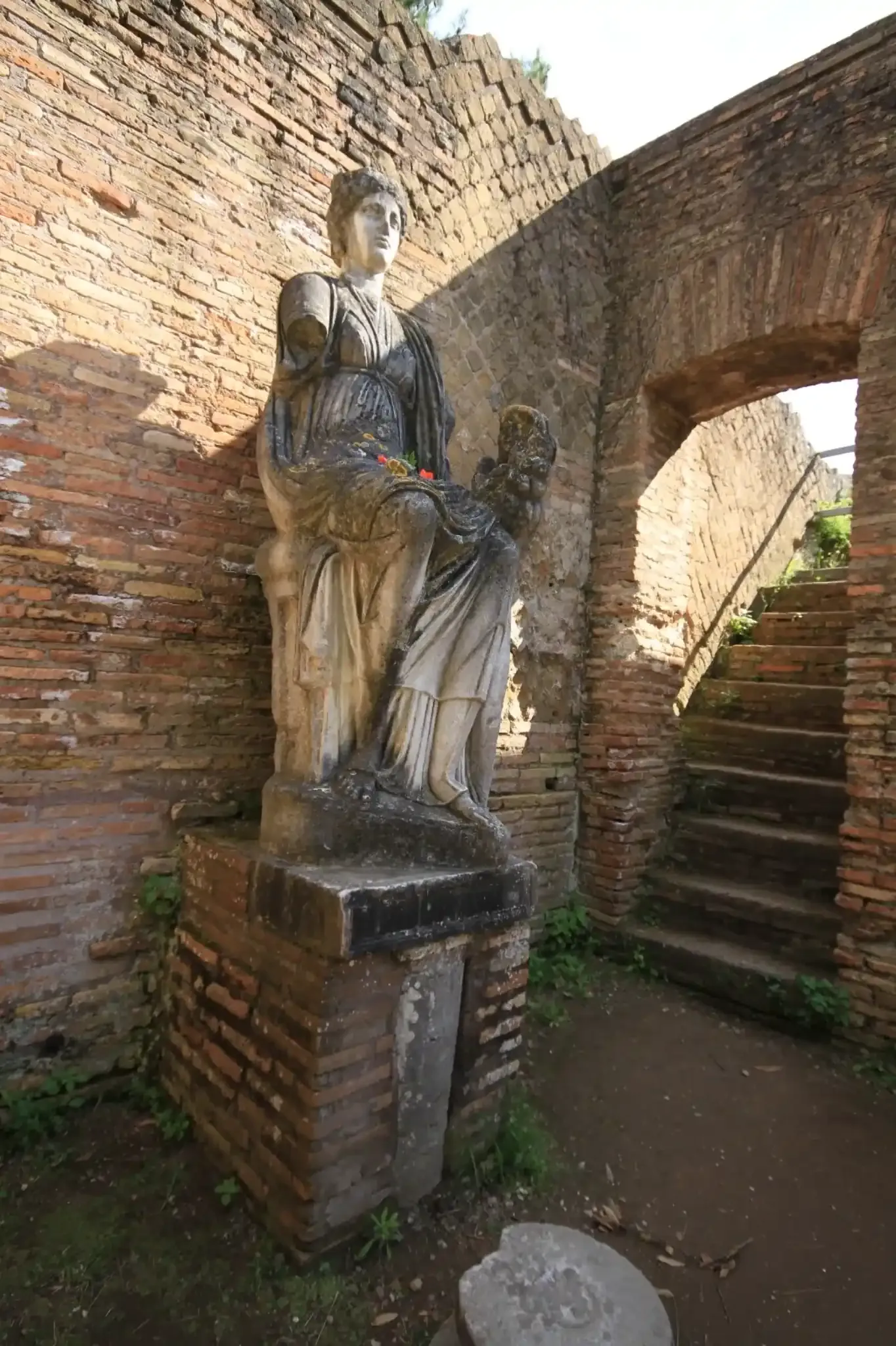 Ancient Roman female statue with classical drapery at Ostia Antica archaeological site
