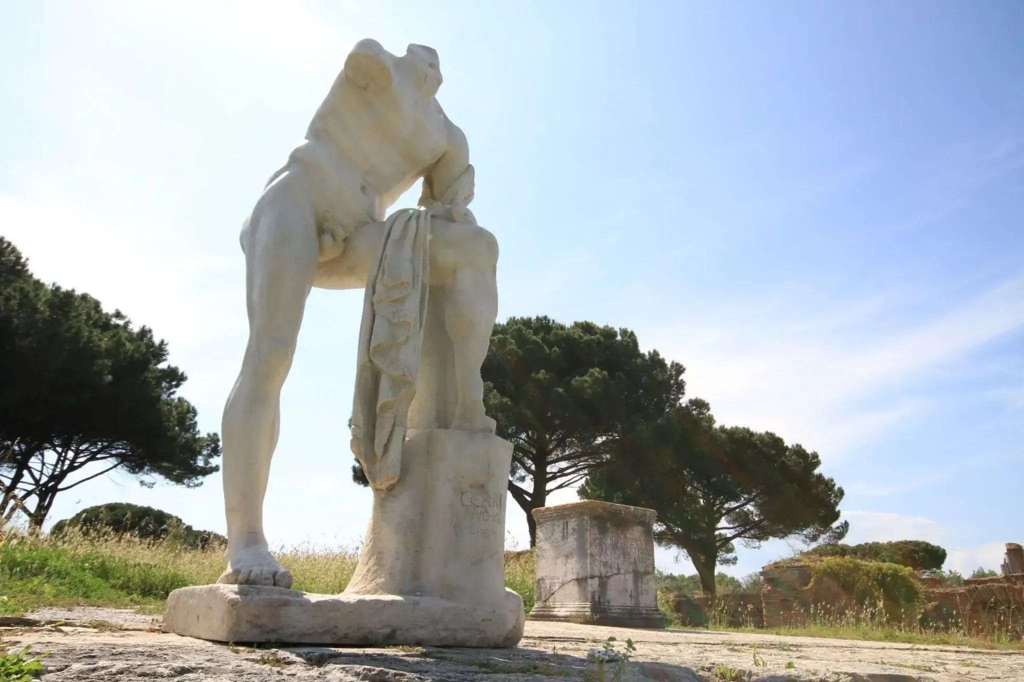 Marble male statue with draped cloth at Ostia Antica ancient Roman port city ruins