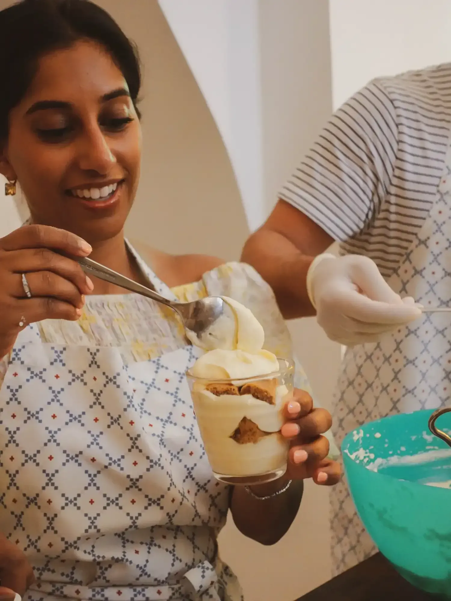 Participant tasting freshly prepared tiramisu with mascarpone cream and cocoa powder during cooking class