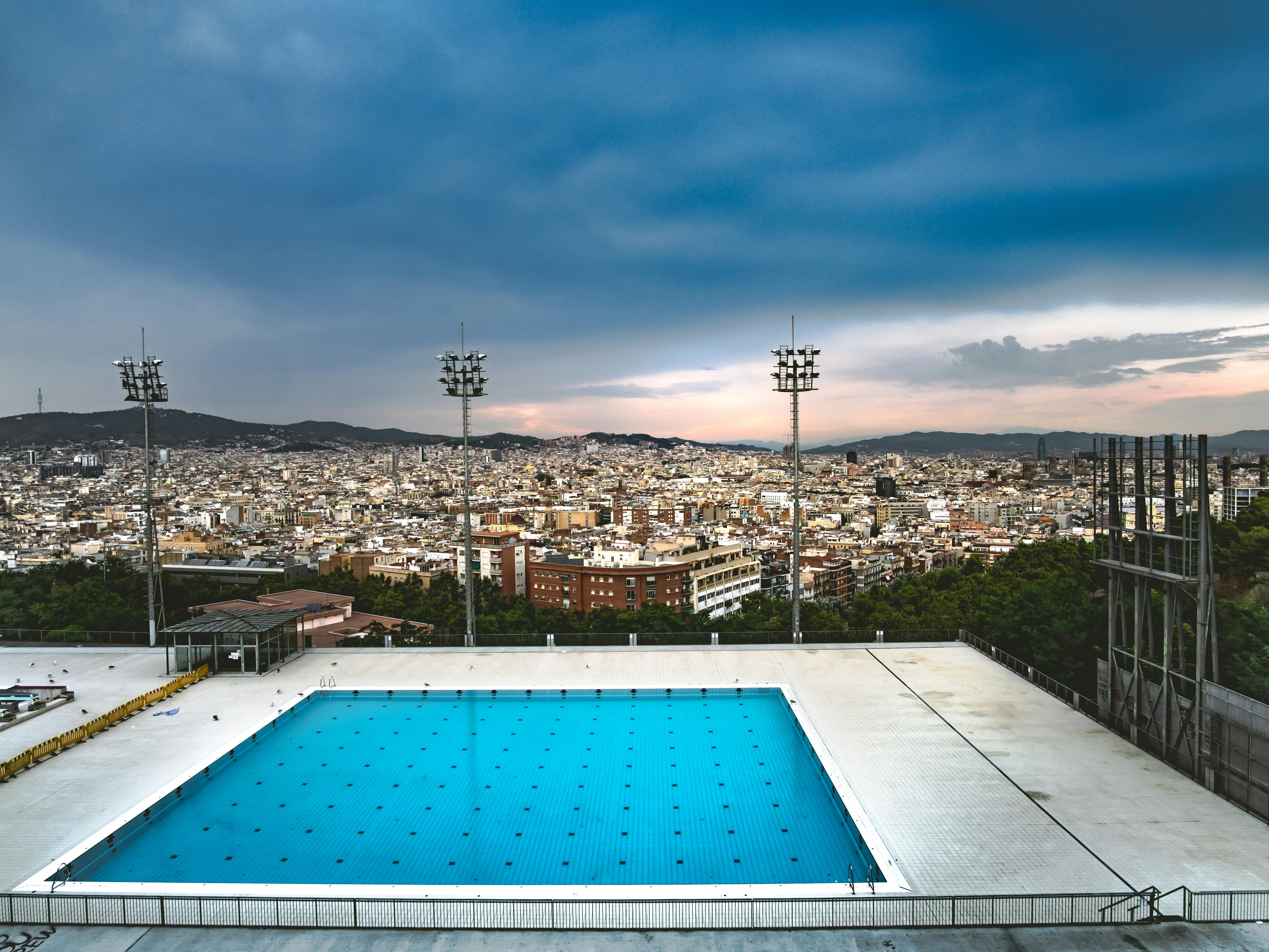 View of the olympic swimming pool and Barcelona cityscape at Salts