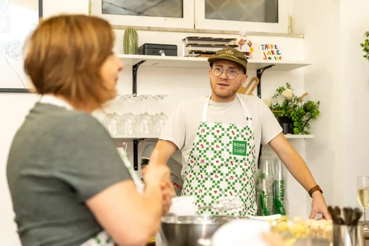 Woman smiling while enjoying meal at restaurant table during Pizza & Tiramisu Class food tour