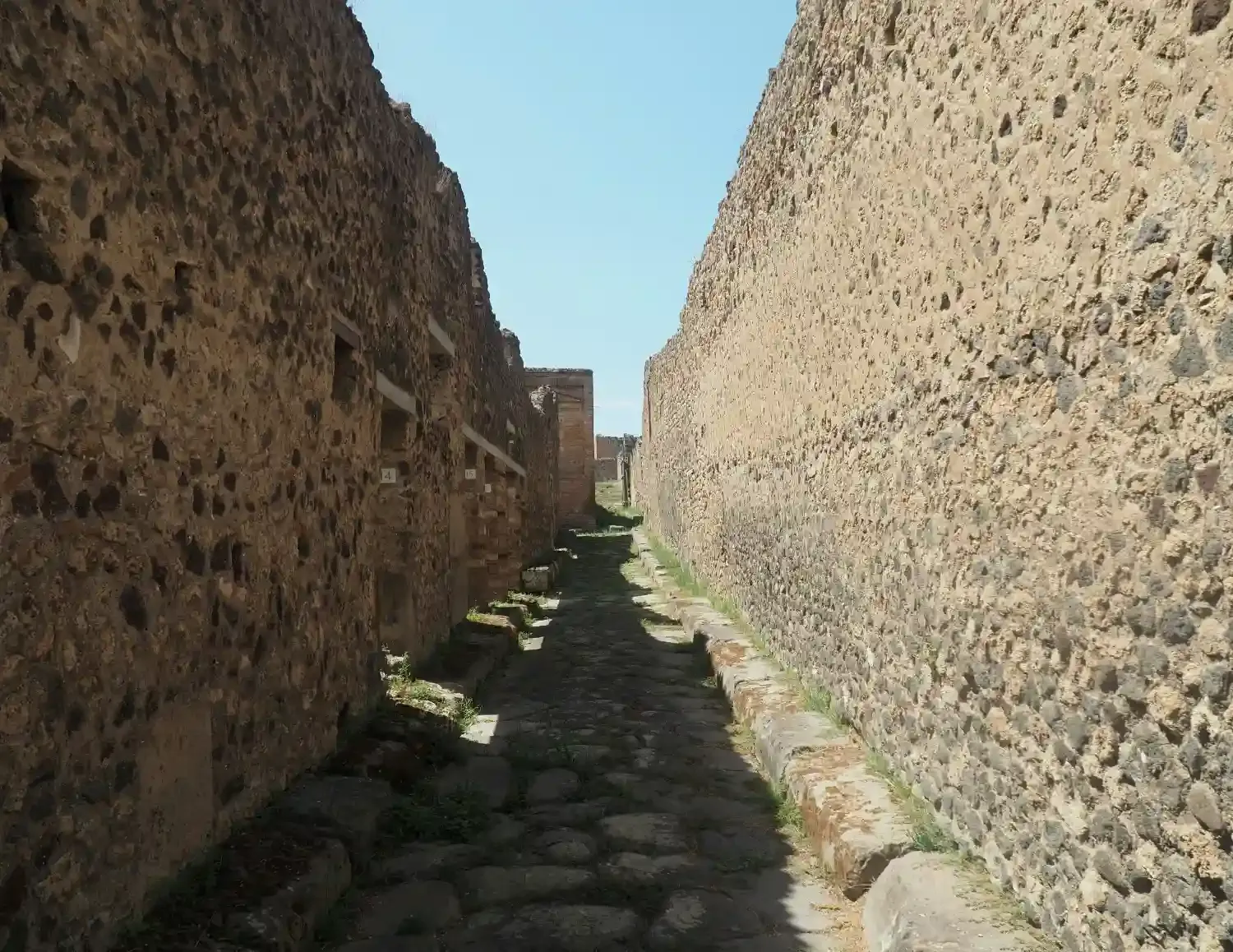 Preserved Pompeii Roman house interior with ancient walls, doorways, and archaeological remains from volcanic preservation