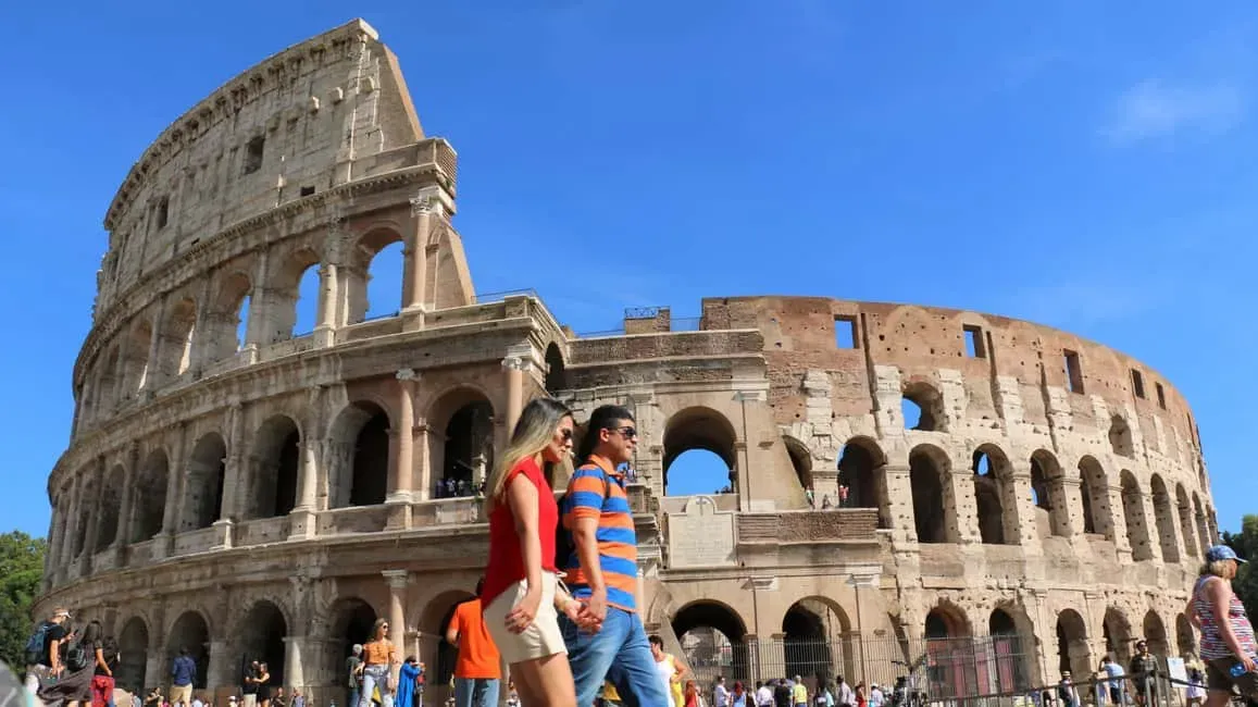 Visitors exploring the iconic Colosseum amphitheater with ancient Roman architectural ruins
