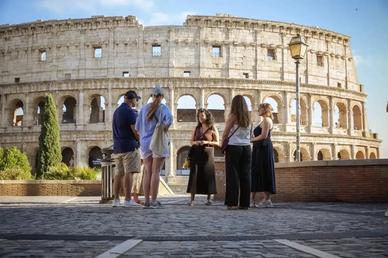 Group of travelers at Roman Forum with Rome cityscape on Colosseum tour